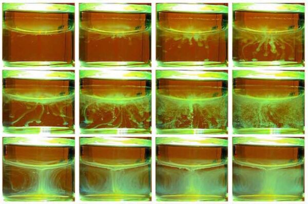 In a sequence of 12 images, light green precipitate forms in clear fluid against a dark orange background.